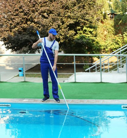 Male,Worker,Cleaning,Outdoor,Pool,With,Scoop,Net